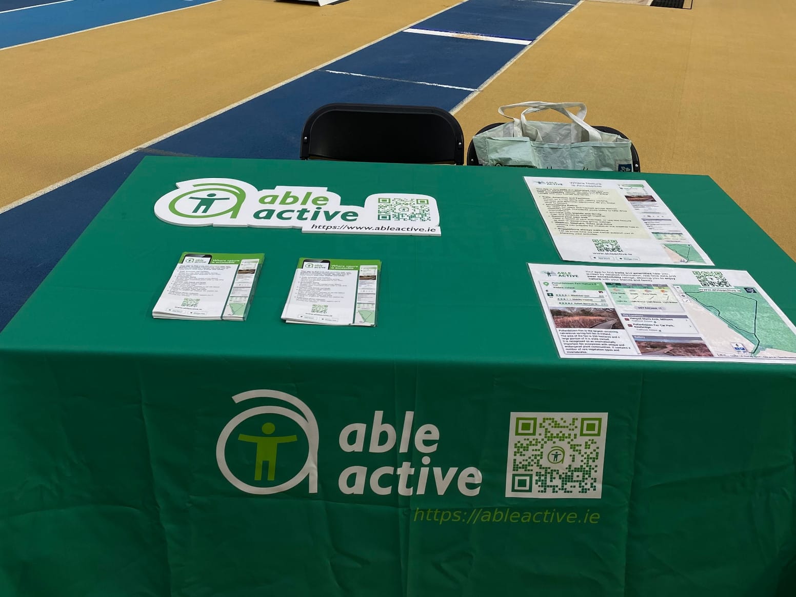 Exhibitor table with Ale Active branded tablecloth and posters